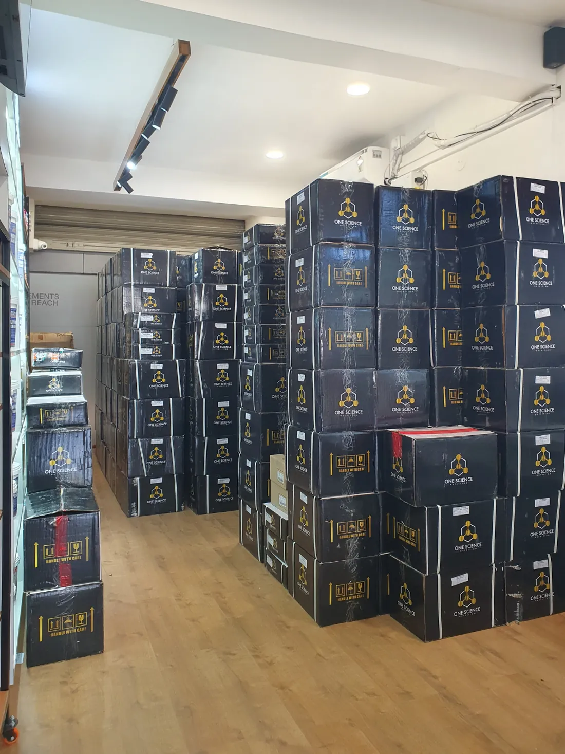 Stocked cartons of One Science Nutrition products in the GetFit Ventures inventory room